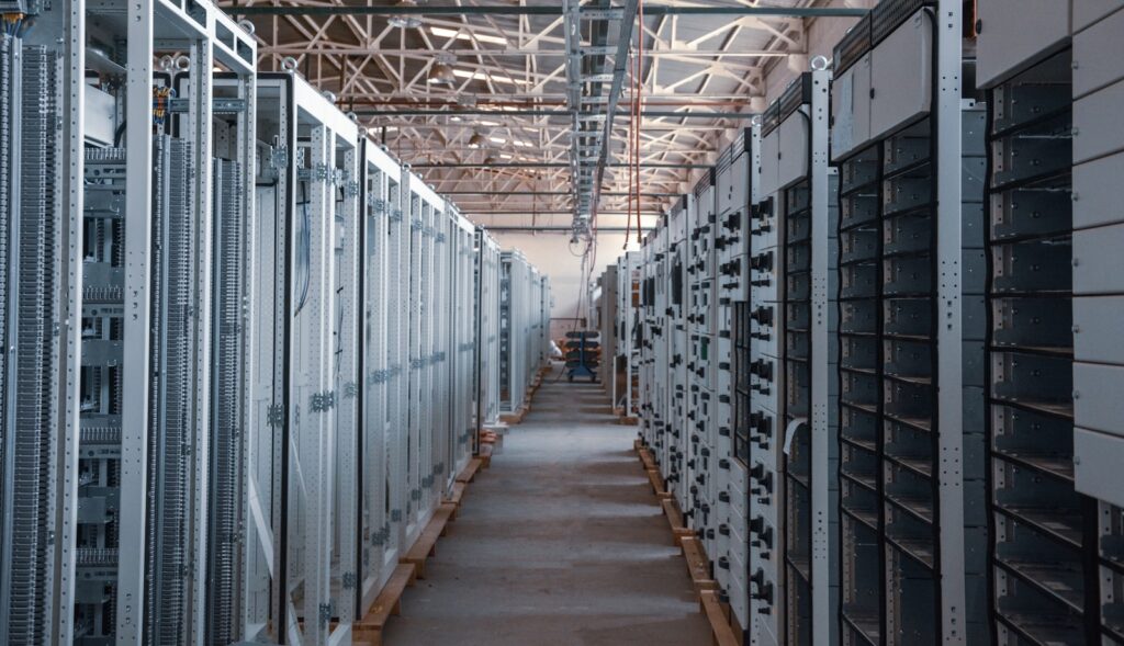 Long aisle of server racks inside a data center hall