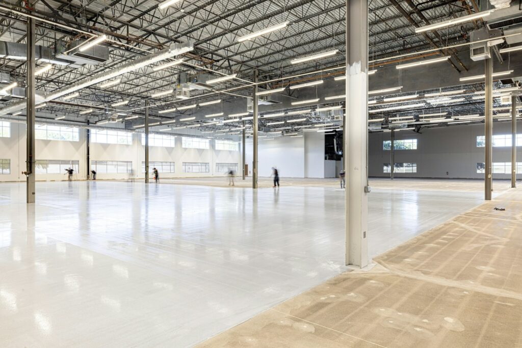 Empty modern industrial hall being prepared for data center fit-out